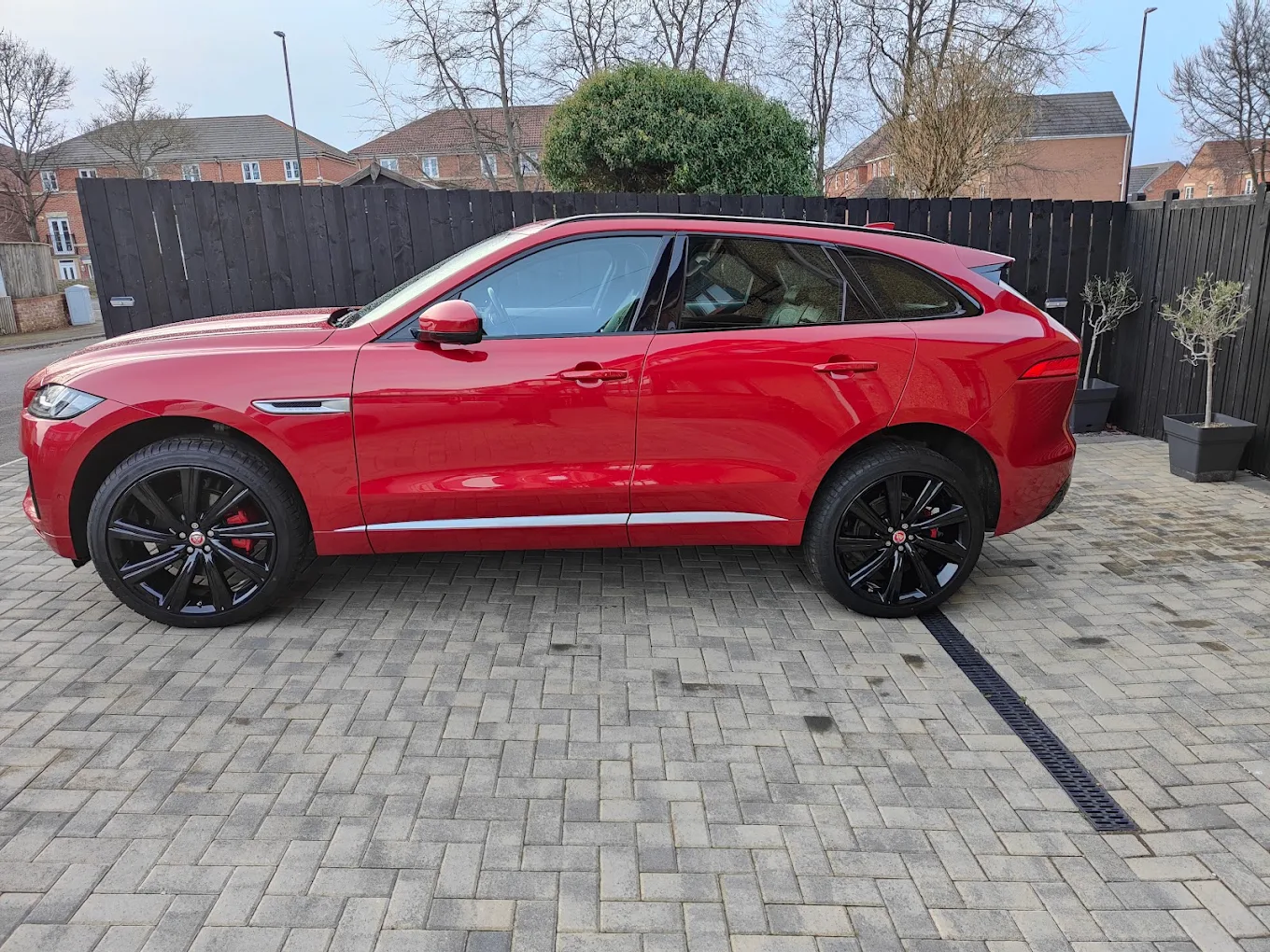 Red Jaguar with refurbished alloy wheels